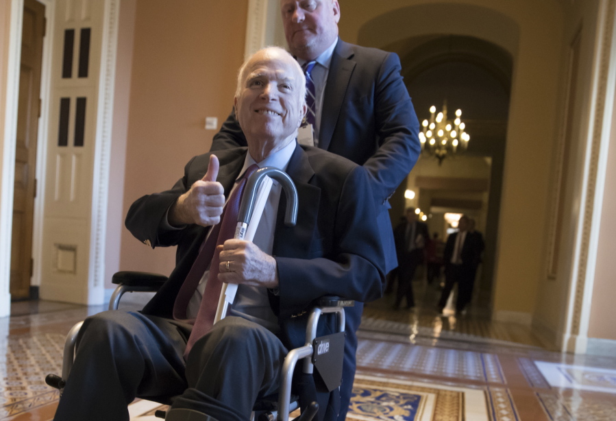 Sen. John McCain, R-Ariz., leaves a closed-door session where Republican senators met on the GOP effort to overhaul the tax code, on Capitol Hill in Washington. President Donald Trump says McCain is returning home to Arizona after being hospitalized over the side effects from his brain cancer treatment. The 81-year-old McCain has been hospitalized at Walter Reed Medical Center in Maryland. (AP Photo/J.