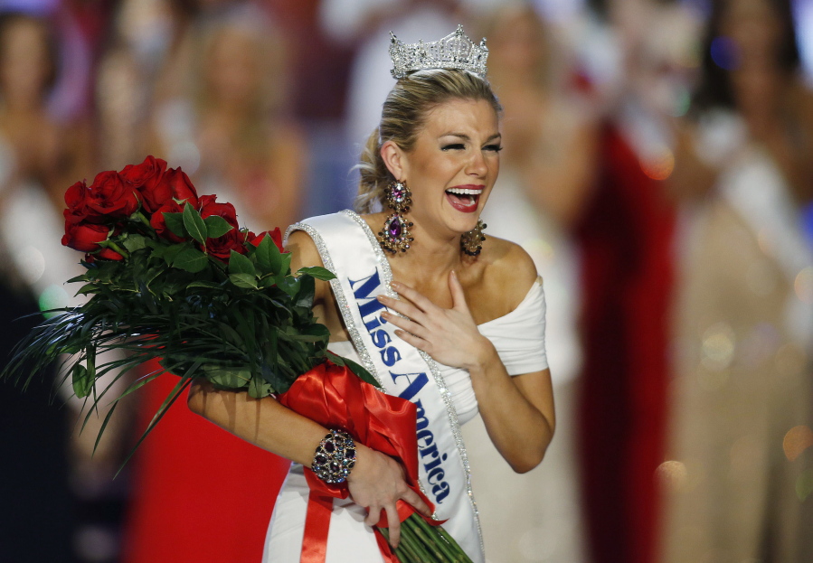 FILE - In this Jan. 12, 2013 file photo, Miss New York Mallory Hytes Hagan reacts as she is crowned Miss America 2013 in Las Vegas. Some former Miss Americas shamed in emails from the pageant’s CEO are calling on him and other leaders of the Miss America Organization to resign. Hagan’s appearance and sexual habits were mocked in the emails.