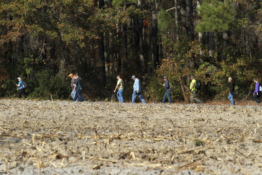 Volunteers and officials search a wooded area for 3-year-old Mariah Woods on Friday in Jacksonville, N.C.