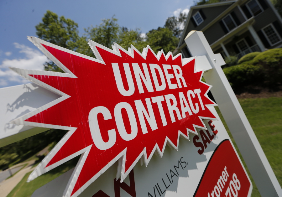 A sign in May advertises that an existing home for sale is under contract in Roswell, Ga. Surging stock prices and steady increases in home values powered American household wealth to $96.9 trillion in the fall of 2017, though the gains aren’t widely shared.