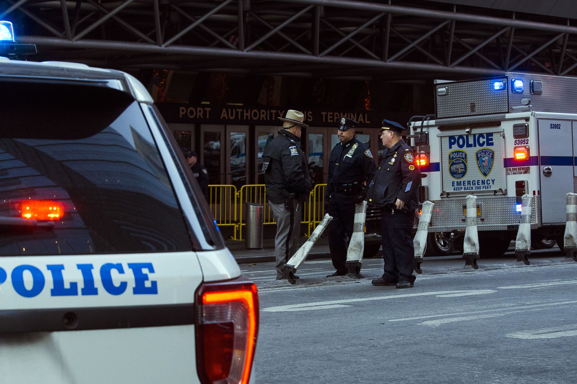 Police stand guard in front of the Port Authority Bus Terminal near New York, Times Square following an explosion on Monday, Dec. 11, 2017. Police say the explosion happened in an underground passageway under 42nd Street between 7th and 8th Avenues.