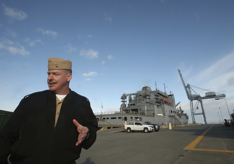 Naval Magazine Indian Island Cmdr. Rocky Pulley talks about loading ships, such as the USNS Cesar Chavez seen behind him, at the pier on Nov. 17. Naval Magazine Indian Island is the last stop for many ships before they head out to the open ocean. Meegan M.