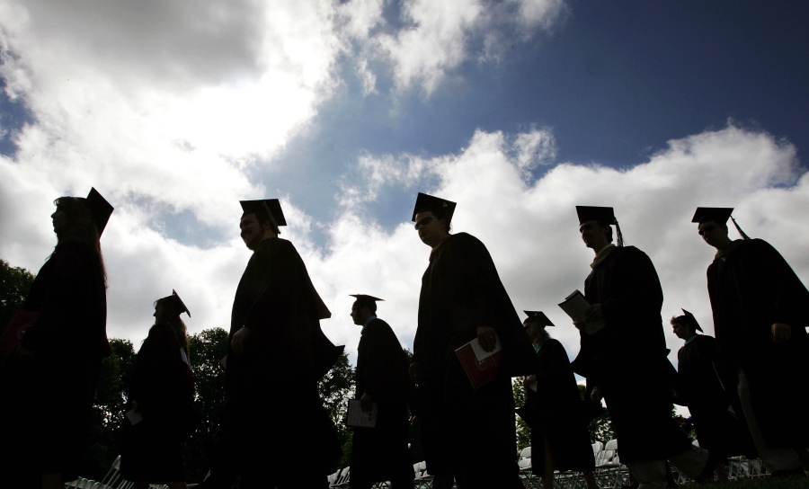 University students in their caps and gowns are silhouetted as they line up for graduation ceremonies in Lawrenceville, N.J., in 2006.