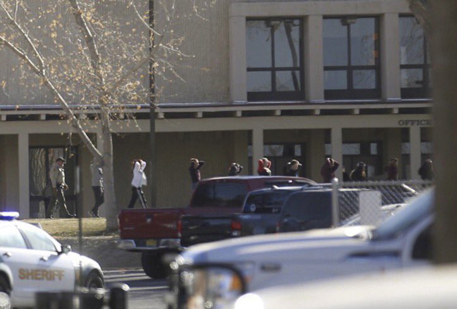 Students are led out of Aztec High School after a shooting Thursday in Aztec, N.M. The school is in the Four Corners region and is near the Navajo Nation.