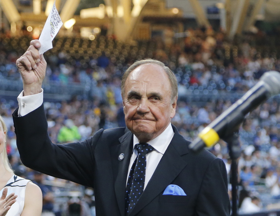 FILE - In this Sept. 29, 2016, file photo, San Diego Padres broadcaster Dick Enberg waves to crowd at a retirement ceremony prior to the Padres’ final home baseball game of the season, against the Los Angeles Dodgers in San Diego. Enberg, the sportscaster who got his big break with UCLA basketball and went on to call Super Bowls, Olympics, Final Fours and Angels and Padres baseball games, died Thursday, Dec. 21, 2017. He was 82. Engberg’s daughter, Nicole, confirmed the death to The Associated Press. She said the family became concerned when he didn’t arrive on his flight to Boston on Thursday, and that he was found dead at his home in La Jolla, a San Diego neighborhood.