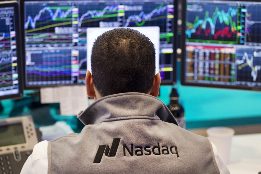 An employee monitors prices at the tech-driven Nasdaq MarketSite in New York. From Silicon Valley to Shanghai, surging share prices for technology companies means the industry is making up an ever-larger chunk of stock funds.
