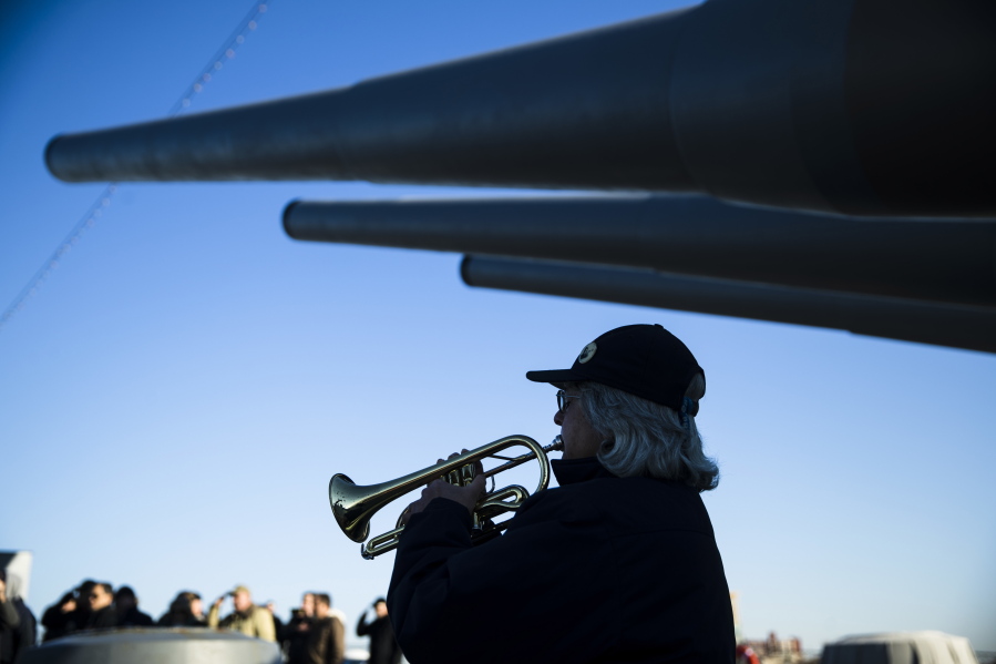Bugler Nan LaCorte play taps during a ceremony commemorating the anniversary of the Dec. 7, 1941 Japanese attack on Pearl Harbor, on board The Battleship New Jersey Museum and Memorial in Camden, N.J., Thursday.