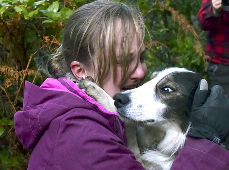Sarah Stremming has a tearful reunion with her dog, Felix, Tuesday after he was rescued from a precipice north of Indian Beach in Ecola State Park in Cannon Beach, Ore.