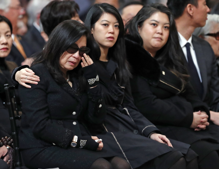 Anita Lee, far left, and her daughters, Brianna, middle, and Tania attend a service celebrating the life of Mayor Ed Lee at San Francisco City Hall in San Francisco, Sunday, Dec. 17, 2017. San Francisco Mayor Ed Lee was remembered for his humility, integrity and infectious smile during a public celebration of his life Sunday at City Hall attended by family members, former staff, politicians and residents.