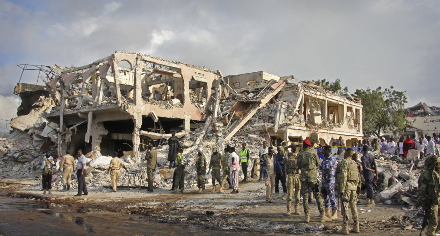 In this Sunday, Oct. 15, 2017 file photo, Somali security forces and others gather and search for bodies near destroyed buildings at the scene of Saturday’s blast, in Mogadishu, Somalia. The final death toll from the Oct. 14 massive truck bombing in Somalia’s capital is 512 people, according to a report by the committee tasked with looking into the country’s worst-ever attack, obtained by The Associated Press Saturday, Dec. 2, 2017.