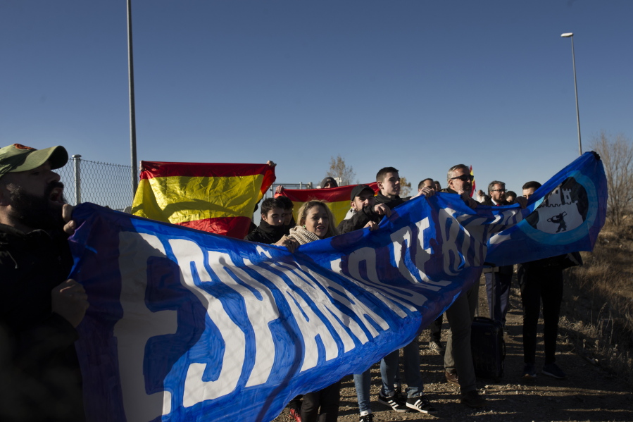 A dozen of far right pro-Spain activists hold up a blue banner reading in Spanish: “Spain does not give up” during a Esquerra de Catalunya (ERC) party campaign act in Estremera prison, central Spain, Tuesday, Dec. 19, 2017. Voters go to polls this week in Spain’s northeastern region of Catalonia in elections called by the Spanish government after it sacked the former regional cabinet and dissolved the local parliament.