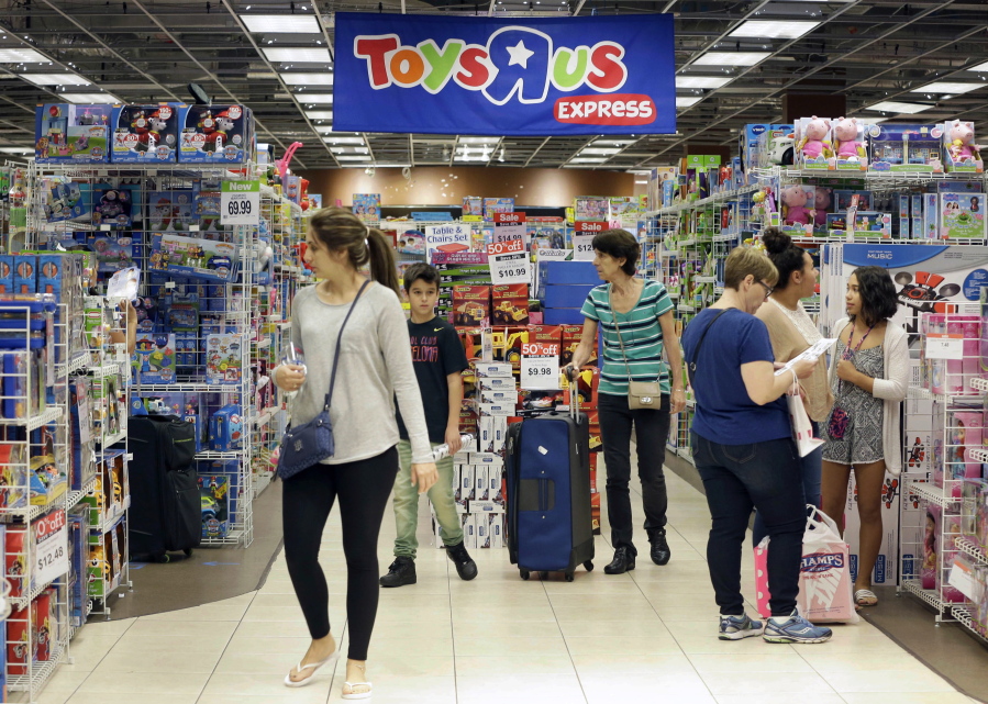 FILE - In this Friday, Nov. 25, 2016, file photo, shoppers browse at a Toys R Us store in Miami. The toys your kids unwrap this Christmas could invite hackers into your home. That Grinch-like warning comes from the FBI, which said this summer that toys connected to the internet could be a target for crooks who may listen in on conversations or use them to steal a child’s personal information.