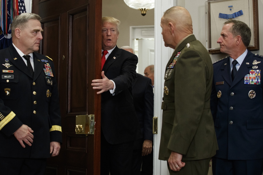President Donald Trump arrives for a ceremony to sign the National Defense Authorization Act for Fiscal Year 2018, in the Roosevelt Room of the White House, Tuesday in Washington.