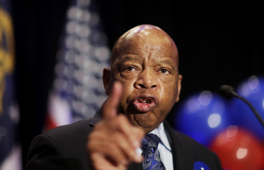 FILE- In this June 20, 2017 file photo, Rep. John Lewis, D-Ga., speaks at an election night party for Democratic candidate for 6th congressional district Jon Ossoff in Atlanta. Lewis announced Thursday, Dec. 7 that he won’t speak at the opening of Mississippi civil rights and history museums on Saturday, saying it’s an “insult” that President Donald Trump will attend.