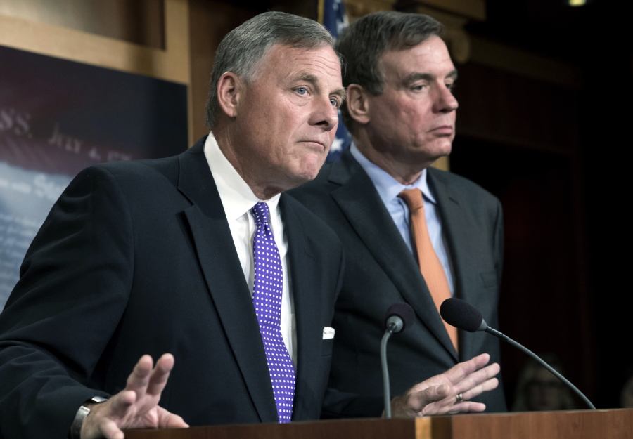 In this Oct. 4, 2017 file photo, Senate Select Committee on Intelligence Chairman Richard Burr, R-N.C., left, and Vice Chairman Mark Warner, D-Va., update reporters on the status of their inquiry into Russian interference in the 2016 U.S. elections, at the Capitol in Washington. (AP Photo/J.