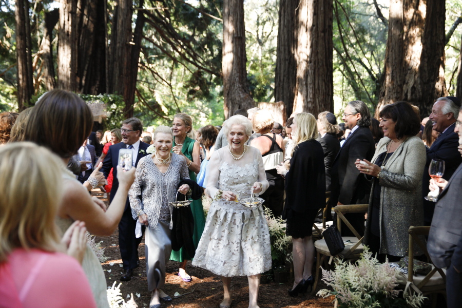 In this May 30, 2015 photo, Flossie “Grammy” Pack, left center, and Nancy “Grongong” Rutchik, right center , walk down the aisle as flower girls for the wedding of their granddaughter Lucy Schanzer in Carmel, Calif. Lucy married Kyle Schanzer.