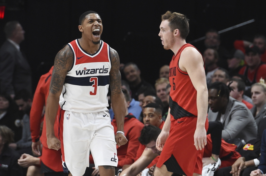 Washington Wizards guard Bradley Beal reacts after hitting a shot as Portland Trail Blazers guard Pat Connaughton walks nearby during the second half of an NBA basketball game in Portland, Ore., Tuesday, Dec. 5, 2017.