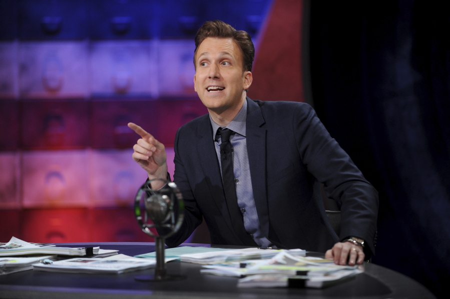 This Sept. 25, 2017 image released by Comedy Central shows comedian Jordan Klepper hosting the premiere of “The Opposition w/ Jordan Klepper” in New York. Adapting to the current media ethos with its ever harsher, ever more absurdist pitch, Klepper hosts a supercharged version of “The Colbert Report,” whose time slot he inherited in September when he unveiled his fake rantcast.