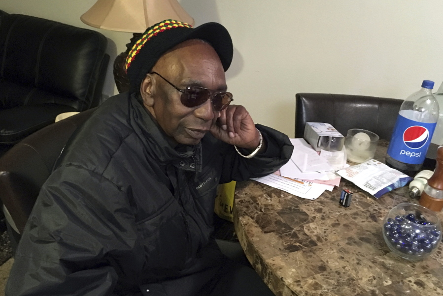 In this Monday, Nov. 27, 2017 photo, Zimbabwean dissident Thomas Mapfumo, Zimbabwe’s most famous musician, pauses while speaking at his apartment in Eugene, Ore. As Zimbabweans celebrated the ouster of dictator Robert Mugabe, they danced on the streets to previously banned protest songs by one of the country’s most famous musicians, Mapfumo, a man jailed by the country’s former white rulers and hounded by the black government that succeeded them.