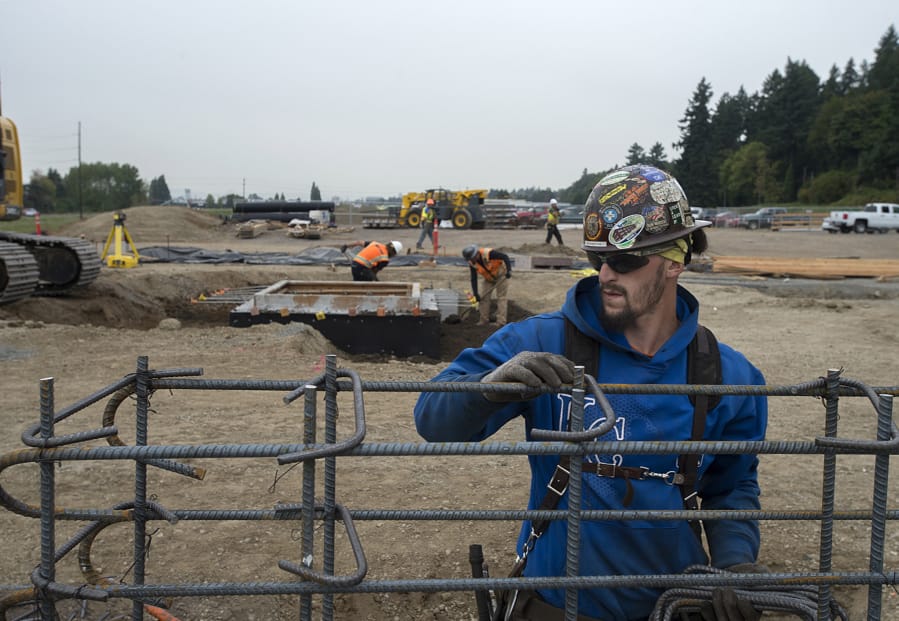 C.J. Barton lends a hand with construction of the new Quad Industrial Park in October. Construction jobs, and many other labor professions, are among the fastest-growing jobs in Clark County heading into the new year.