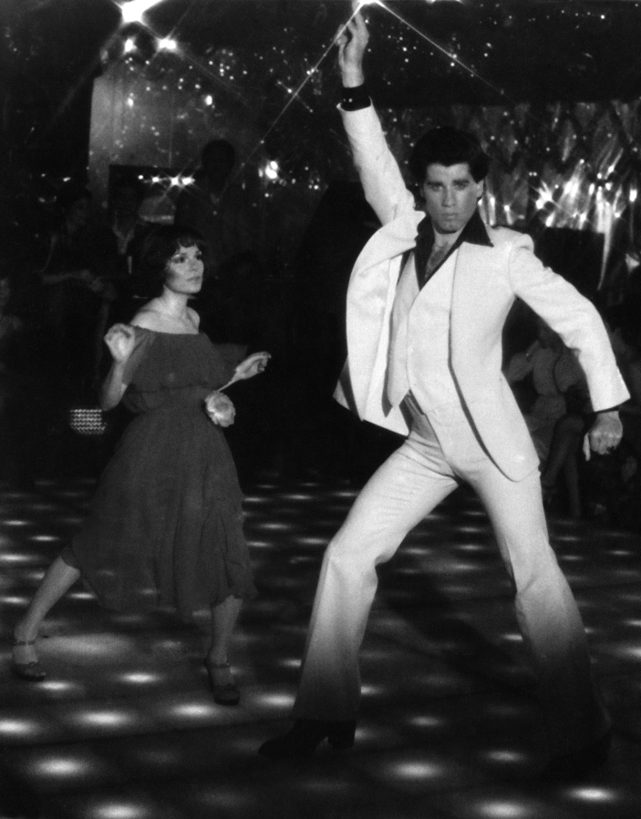 Karen Gorney and John Travolta dance to disco music in “Saturday Night Fever.” The soundtrack was the first to score four No. 1 singles.