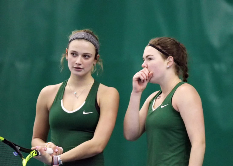 Portland State tennis players Alli Valk, left, and Brianna Thompson, talk strategy during their No. 1 doubles match on Sunday, Jan. 21, against South Dakota at Evergreen Tennis Center in Camas.