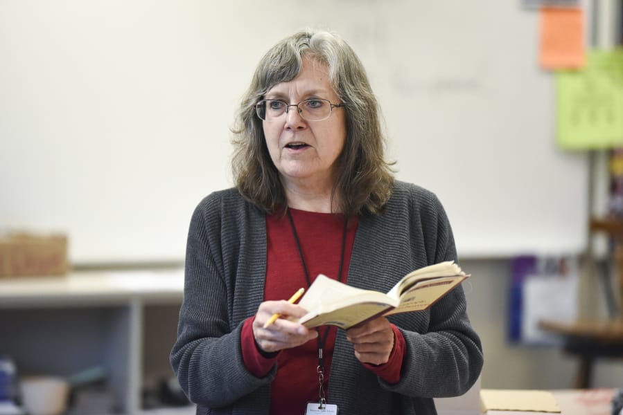 Substitute teacher Carolyn Rose reads the book, “The Five People You Meet in Heaven” to a senior English class at Hudson’s Bay High School in December.