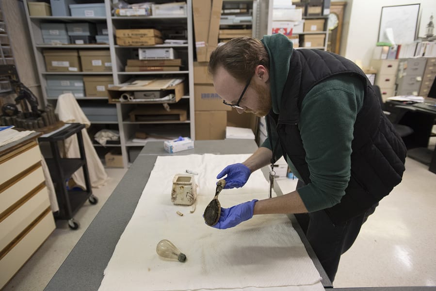 James Kice, administrative assistant for Clark County Historical Museum, looks over a comb that was recovered when they built one of The Columbian’s parking lots.