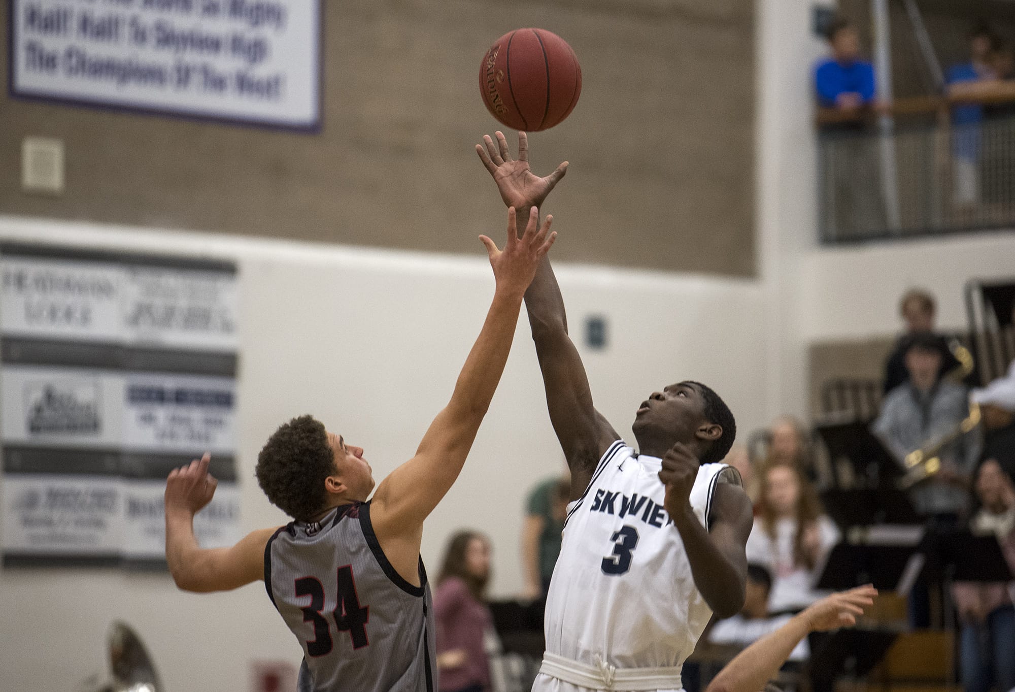Union's Jason Franklin Jr (34) and Skyview's Samaad Hector (3) face off at tipoff, Hector gaining possession for Skyview, at the start of Friday night's game at Skyview High School in Vancouver on Jan. 5, 2018. Skyview defeated Union 59-55.
