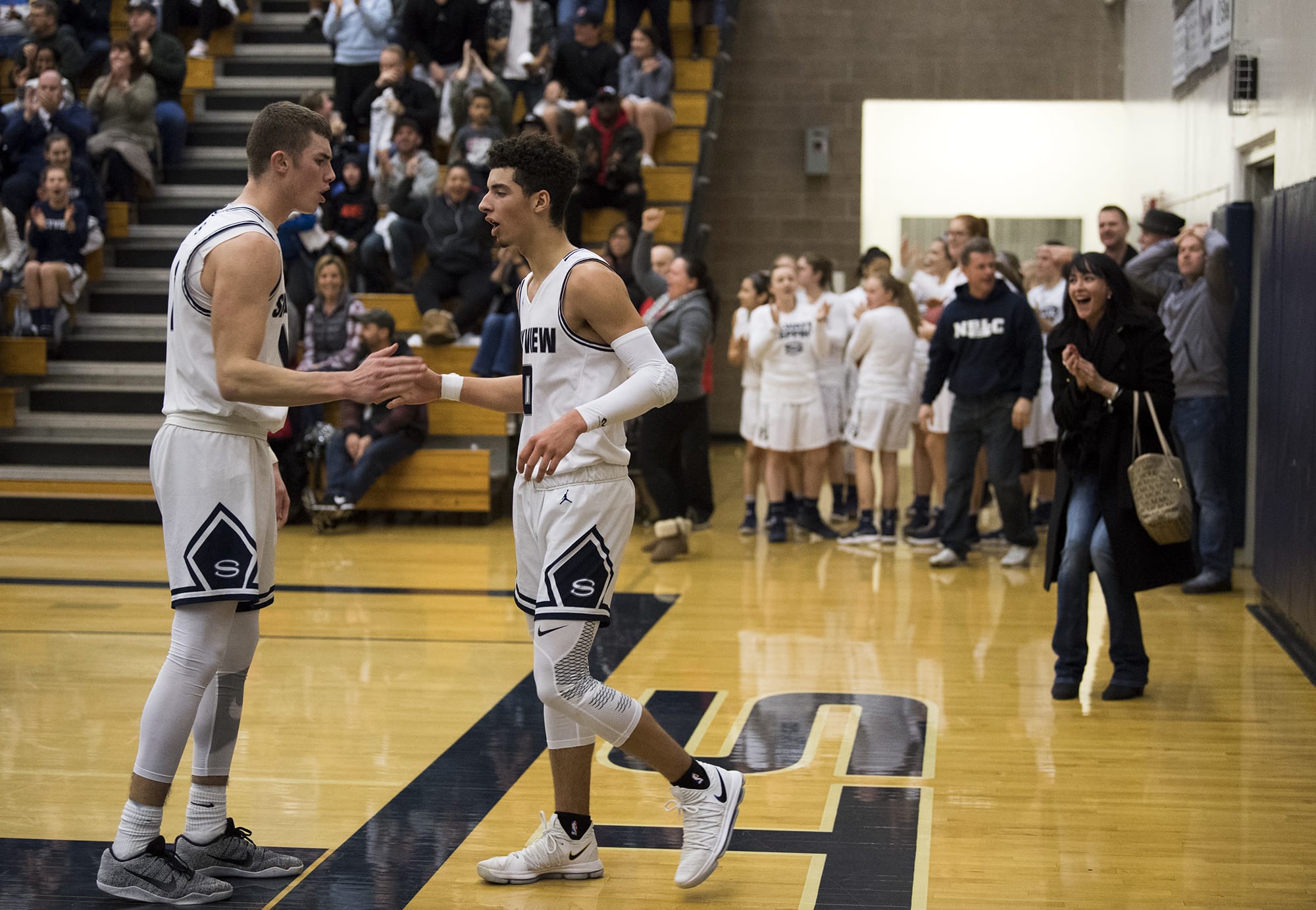 Skyview's Cole Grossman (1) congratulates Alex Schumacher (0) after a basket in the final moments of Friday night's game against Union at Skyview High School in Vancouver on Jan. 5, 2018. Skyview defeated Union 59-55.