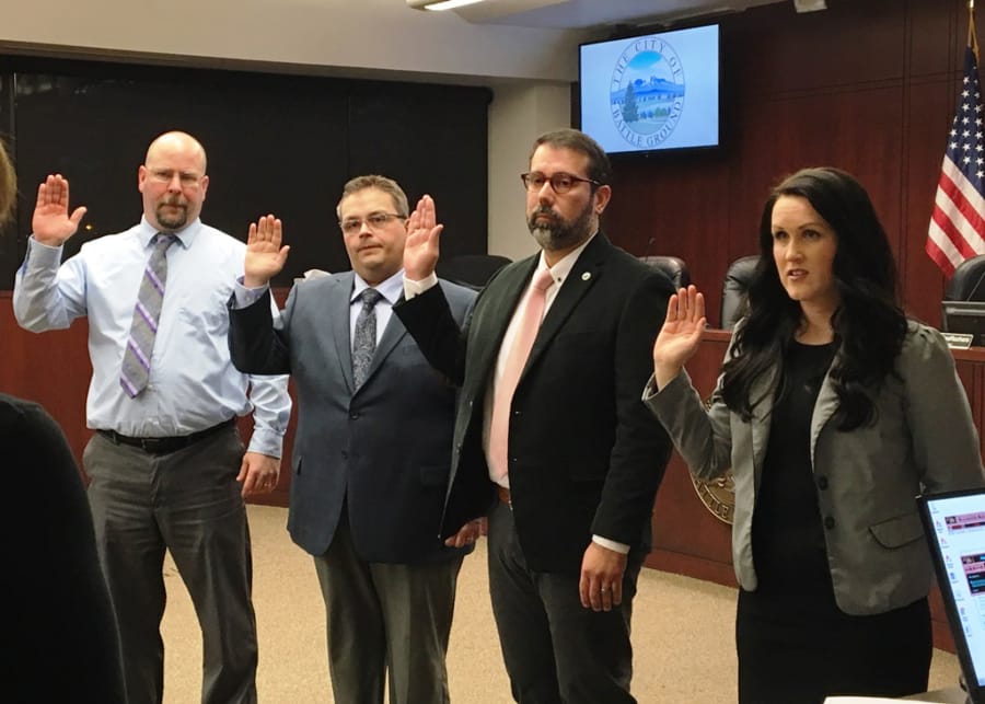 Battle Ground councilors, from left, Brian Munson, Mike Dalesandro, Adrian Cortes and Cherish DesRochers are sworn in for their new terms at Tuesday night’s meeting. Dalesandro was selected by his fellow councilors to be the city’s mayor for the next two years.