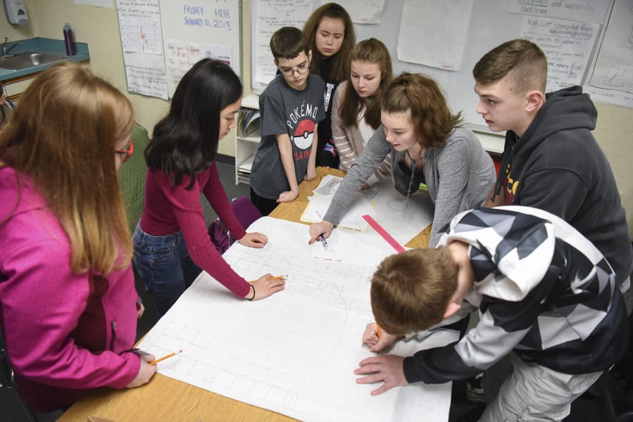 Eighth-graders at Laurin Middle School work together on design plans for their new middle school Friday during their hands-on science elective class led by Joan Smith. Students are split into different teams to design an imagined version of the Brush Prairie school.
