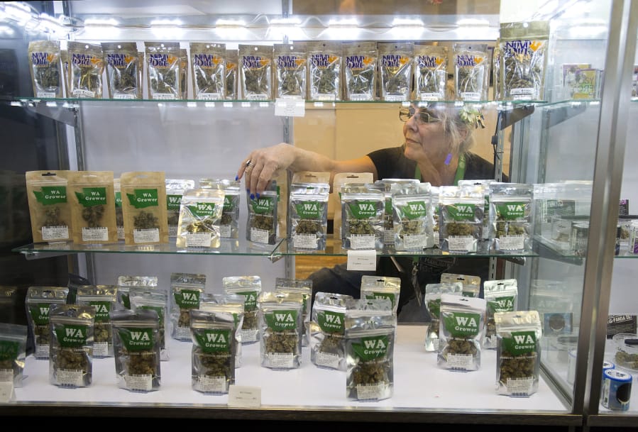 Budtender Cher Poff assists a customer with a purchase while working at Main Street Marijuana on Thursday. Store owner Ramsey Hamide said there is uncertainty in the industry after Thursday’s announcement.
