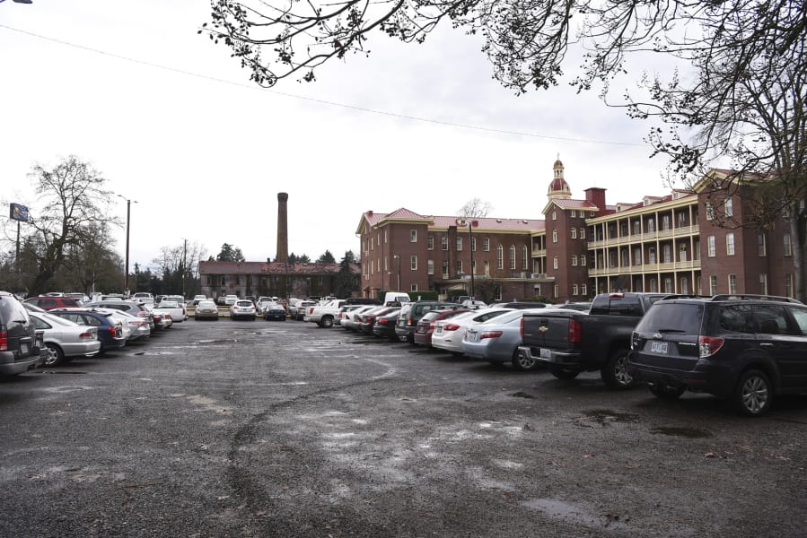 The parking lot west of Providence Academy, along C Street, pictured Friday. Filings with the city of Vancouver show plans to build two mixed-use buildings and parking there.
