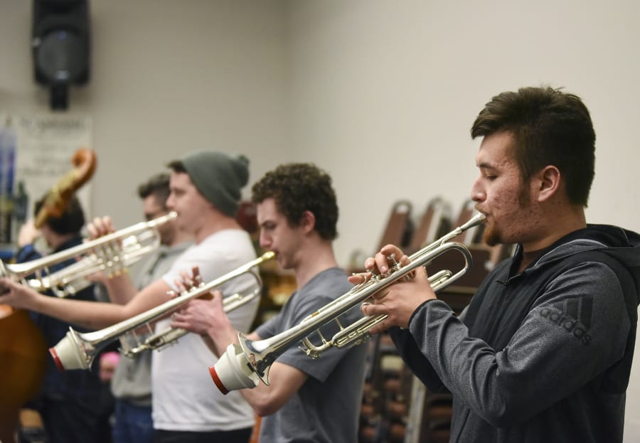 Ariane Kunze/The Columbian Clark College Jazz Ensemble trumpet players Bryce Robertson, left, Connor Wier and Ernest Mattson get ready for the 56th annual Clark College Jazz Festival.