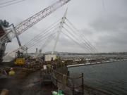 Construction continues at the Grant Street Pier, which recently had its pilings removed and is now floating over the Columbia River by its own cables, Thursday morning, Jan. 11, 2018.