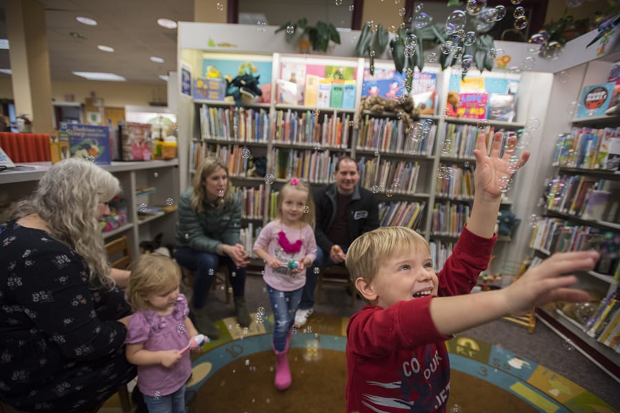 James Tobin, 4, of Ridgefield, in red, joins other participants in children’s story time as they enjoy playing with bubbles at Ridgefield Community Library.