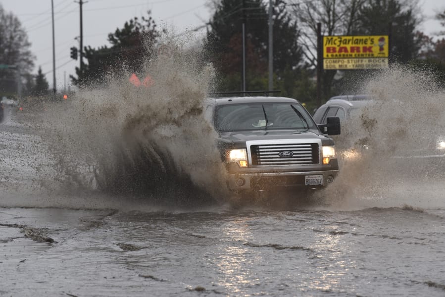 A truck drives through a large pool of standing water on Northeast 117th Avenue in Vancouver near the Goodwill Outlet Store. The pool’s proximity to the thrift store earned it the moniker “Goodwill Lake” to some in the area.