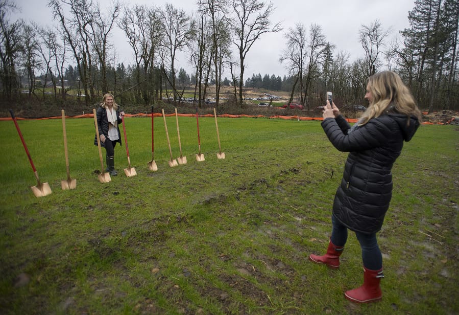 Future homeowner Marcey Erickson of Camas, left, pauses to have her photo taken by Kelsey Kline following the groundbreaking for the 2018 Parade of Homes at The Parklands at Camas Meadows on Wednesday morning.