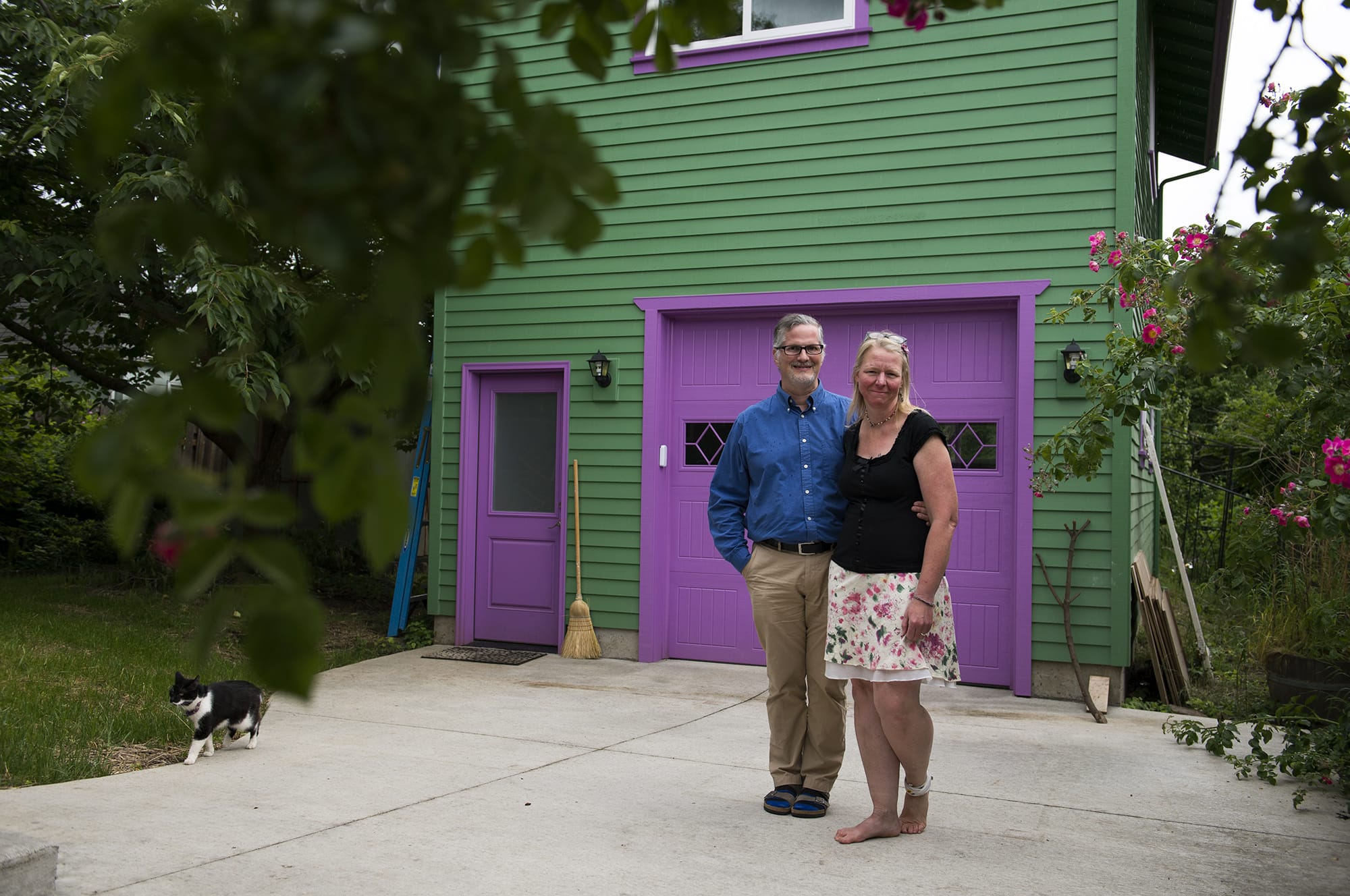 Jennifer and Mark Wyld of Vancouver stand outside their Hough neighborhood home and accessory dwelling unit in June.