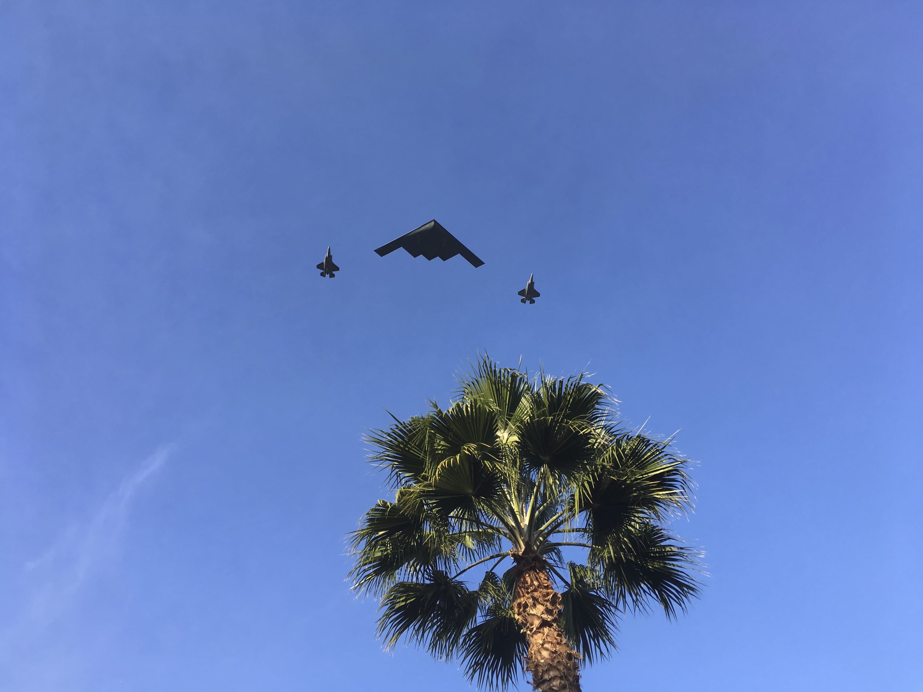 A B-2 Spirit, also known as the Stealth Bomber, and two fighters jets fly over the 2018 Rose Parade route in Pasadena, Calif., Monday, Jan. 1, 2018. The 129th annual parade got started Monday in Pasadena with an announcement by the grand marshal, actor Gary Sinise, and a military flyover. The theme of the 2018 parade is "Making a Difference" and Sinise was chosen to lead the proceedings because of his devotion to veteran's issues.