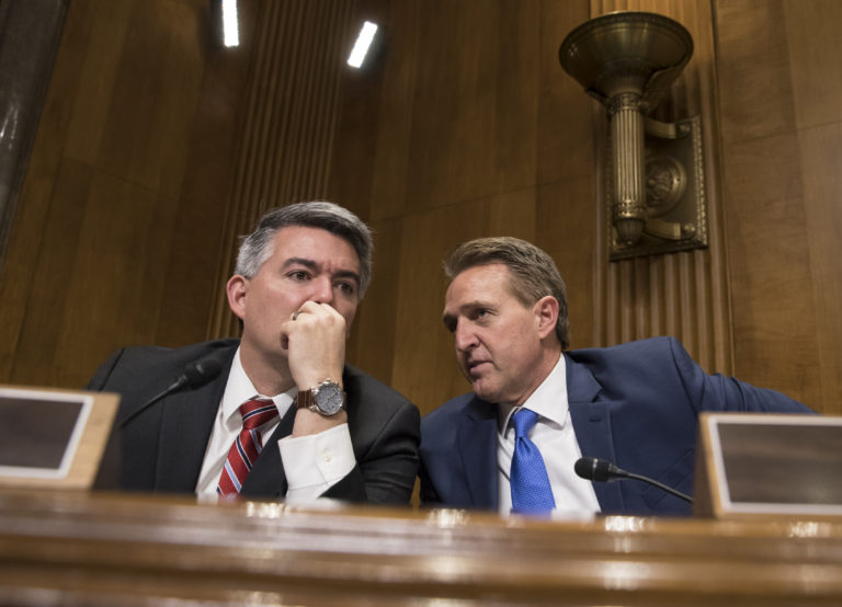 Sen. Cory Gardner, R-Colo., left, and Sen. Jeff Flake, R-Ariz., confer as the Senate Foreign Relations Subcommittee on the Western Hemisphere examines attacks on American diplomats in Havana, on Capitol Hill in Washington, Tuesday, Jan. 9, 2018. (AP Photo/J.