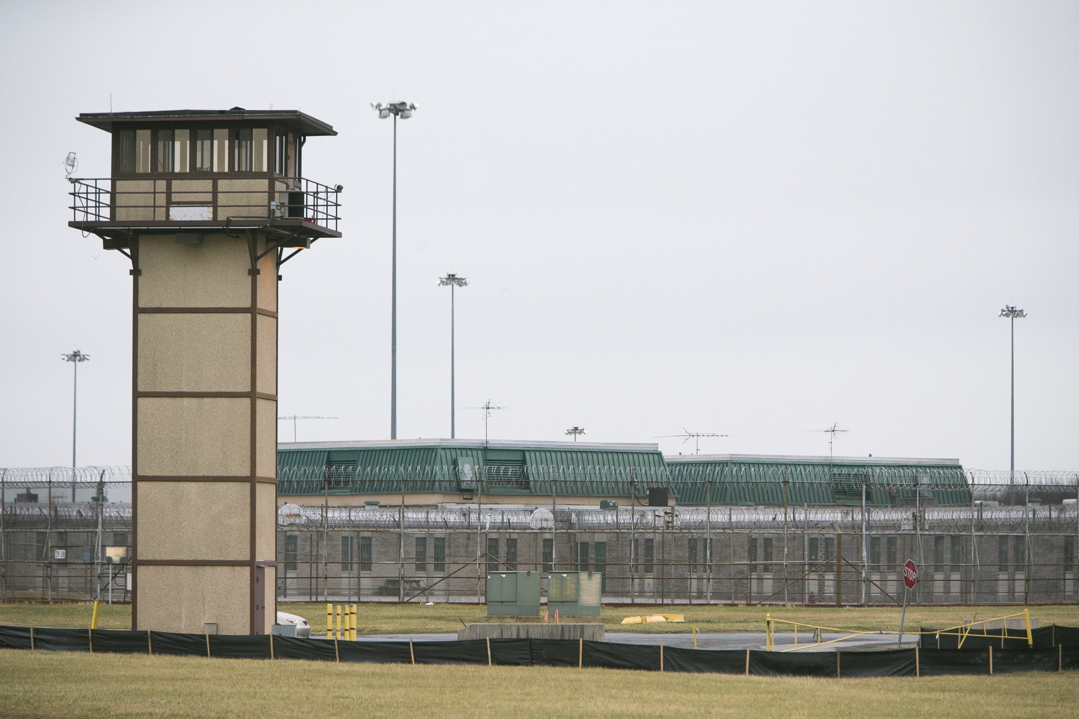 FILE - In this Feb. 1, 2017 file photo, Vaughn Correctional Center near Smyrna, Del., remains on lockdown following a disturbance. State officials are hiring independent experts to review inmate access to health care and the prisoner grievance system in the wake of the deadly inmate riot and hostage taking last year at Delaware's maximum-security prison.