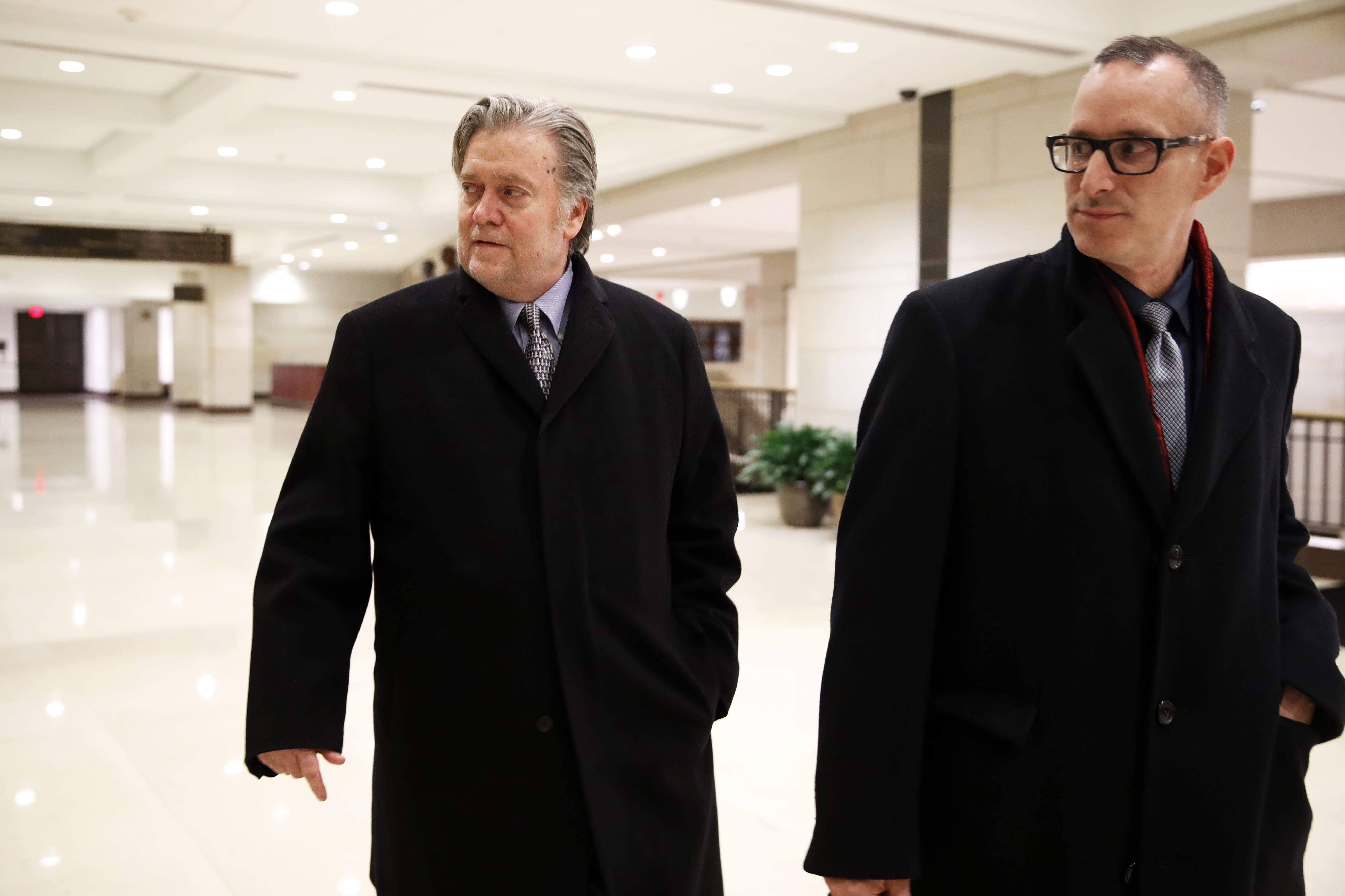 Former White House strategist Steve Bannon, left, leaves a House Intelligence Committee meeting where he was interviewed behind closed doors on Capitol Hill, Tuesday, Jan. 16, 2018, in Washington.
