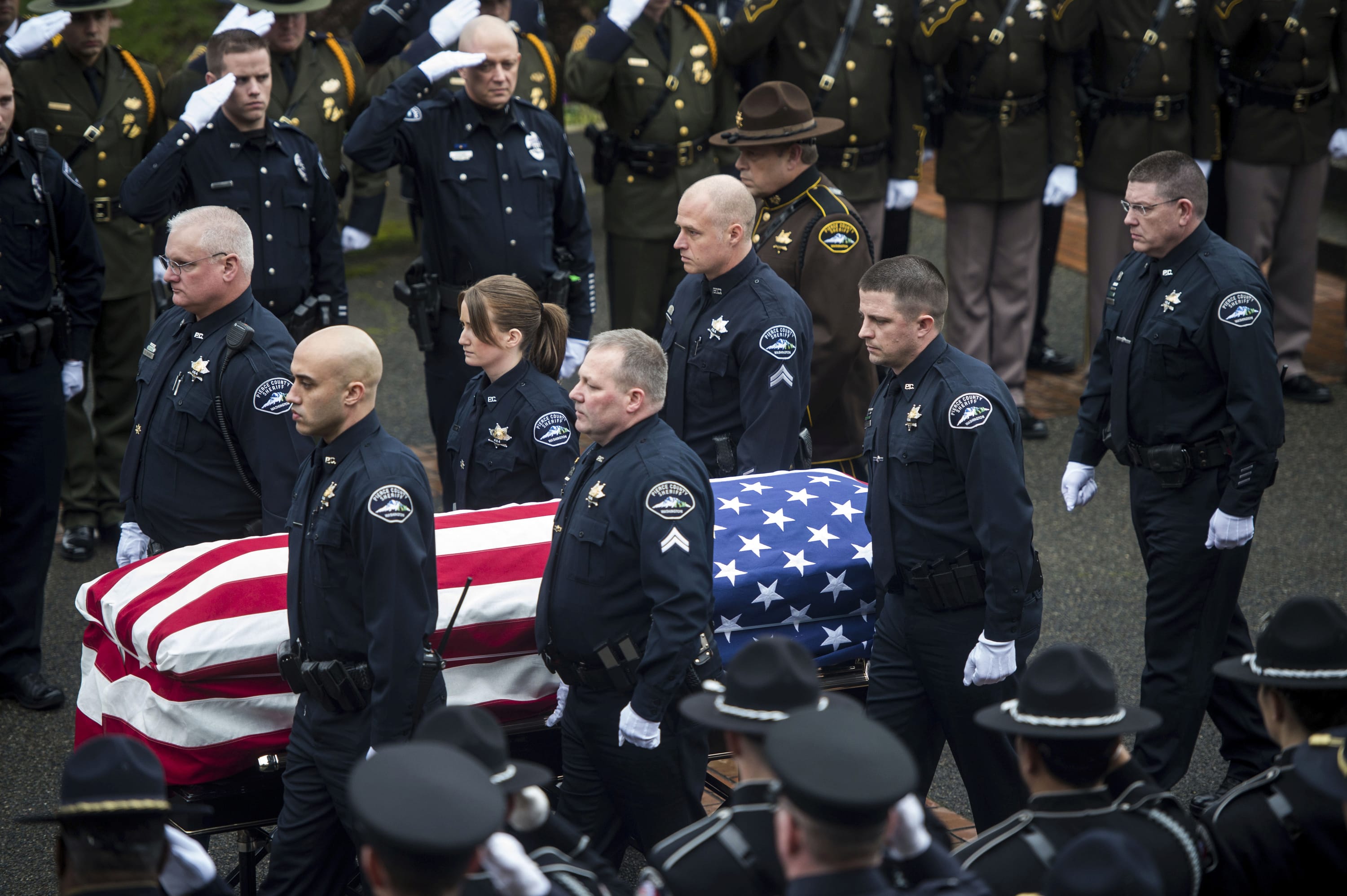 Pallbearers carry Pierce County Sheriff's Deputy Daniel McCartney's casket into Olson Auditorium Wednesday, Jan. 17, 2018, before a memorial service for Pierce County Sheriff's Deputy Daniel McCartney at Pacific Lutheran University in Tacoma, Wash. McCartney died the night of Sunday, Jan. 7, 2018, after being shot while responding to a to a break-in call southeast of Tacoma.