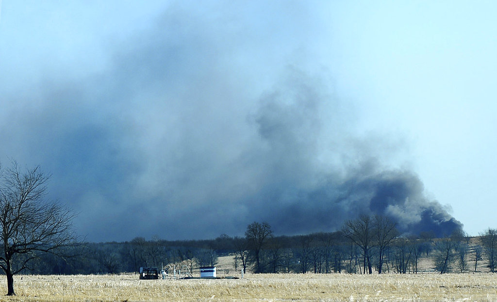 Smoke billows from the site of a gas well fire near Quinton, Okla., early Monday, Jan. 22, 2018. Several people are missing after a fiery explosion ripped through the eastern Oklahoma drilling rig, sending plumes of black smoke into the air and leaving a derrick crumpled onto the ground, an emergency official said.