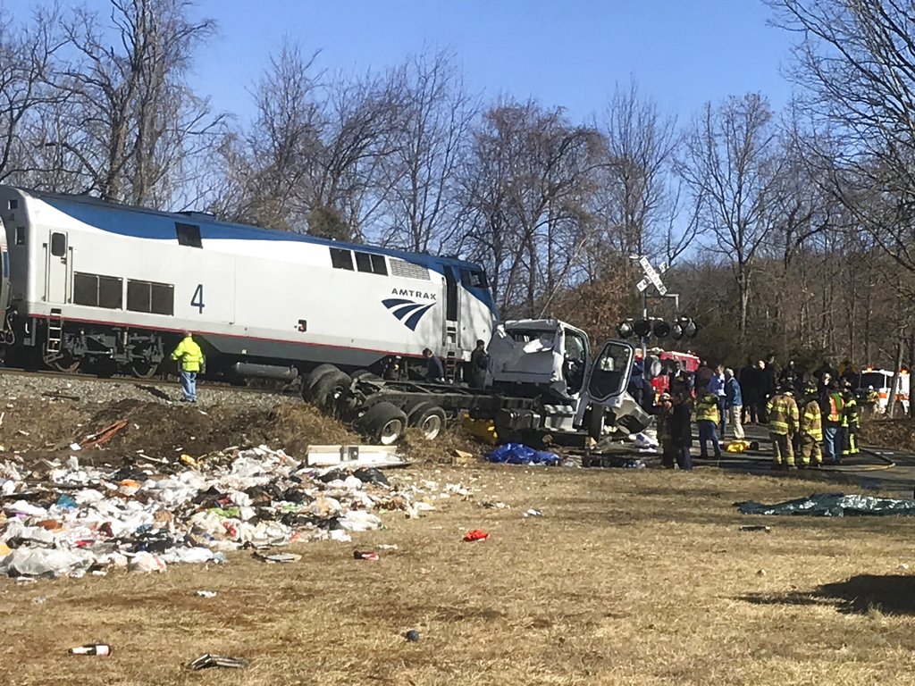 Emergency personnel work at the scene of a train crash involving a garbage truck in Crozet, Va., on Wednesday, Jan. 31, 2018. An Amtrak passenger train carrying dozens of GOP lawmakers to a Republican retreat in West Virginia struck a garbage truck south of Charlottesville, Va. No lawmakers were believed injured, but it at least one person in the truck was said to be seriously injured.