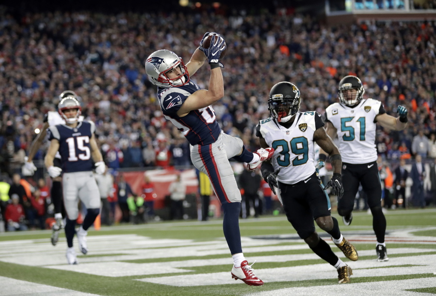 New England Patriots wide receiver Danny Amendola (80) catches a touchdown pass in front of Jacksonville Jaguars safety Tashaun Gipson (39) and linebacker Paul Posluszny (51) during the second half of the AFC championship NFL football game, Sunday, Jan. 21, 2018, in Foxborough, Mass. (AP Photo/David J.