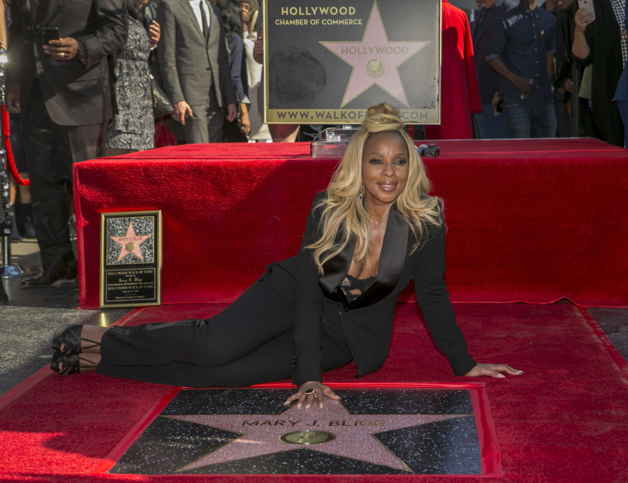 Actress and R&B singer Mary J. Blige touches her star at a ceremony honoring her Jan. 4 on the Hollywood Walk of Fame in Los Angeles.