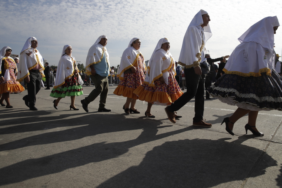 People in traditional dress arrive for a Mass celebrated by Pope Francis at O’Higgins Park in Santiago, Chile, on Tuesday.